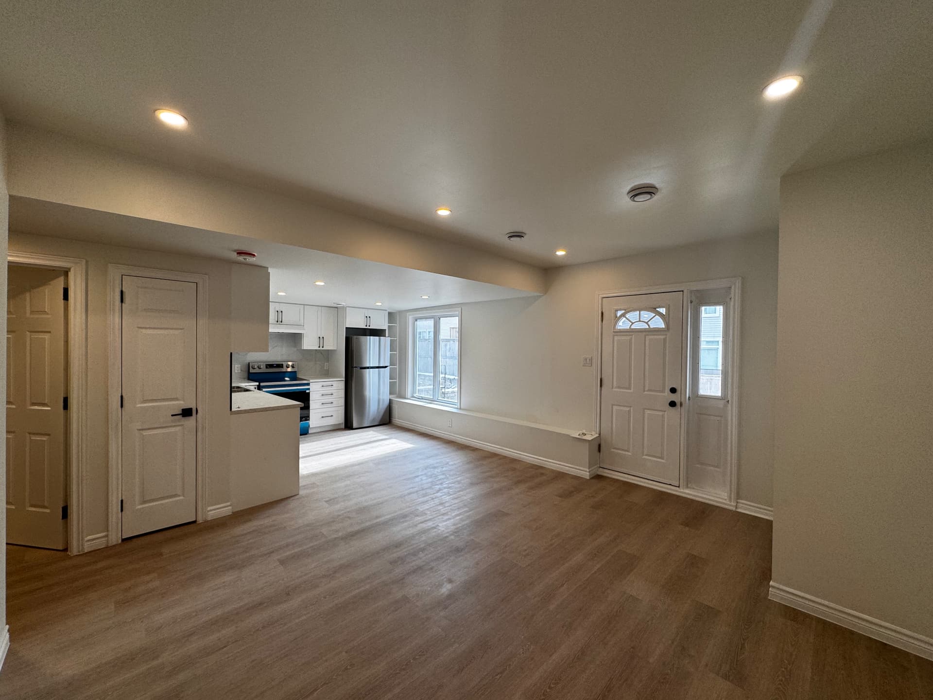 Completed NOOR basement living area with flooring and kitchen